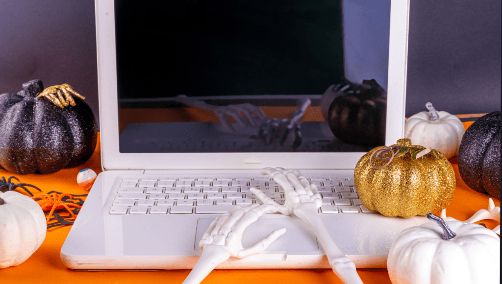 Photo of a skeleton typing on a laptop.